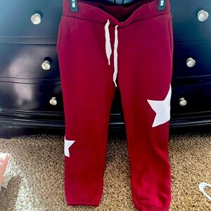 Maroon sweatpants, fleece lined with stars on the legs